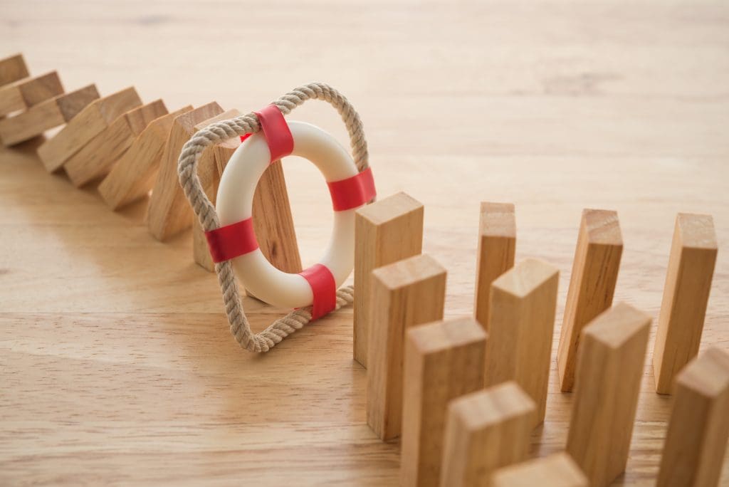 Wooden dominoes with a life preserver in the middle.