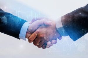 Two people in business suits shaking hands, symbolizing a successful agreement or partnership. A digital overlay with graphs and binary code suggests a technology-driven or financial context.