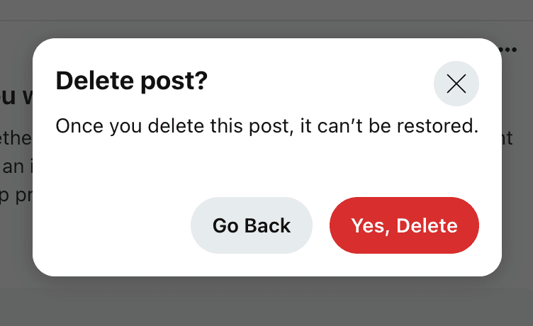 A pop-up window warns, "Delete post? This action is permanent and aligns with Reddit's removal policy." It presents a gray "Go Back" button and a red "Yes, Delete" button, accompanied by a close icon.